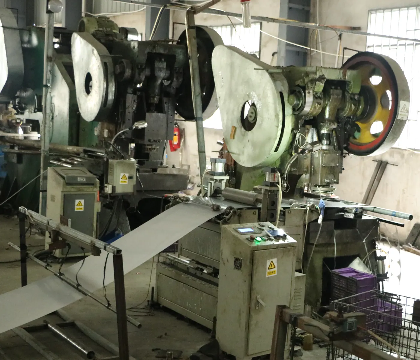 Automatic punch press line stamping stainless steel blanks in the Matewerk workshop