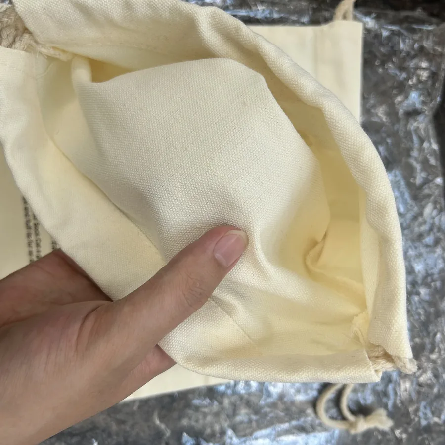 Dense canvas fabric texture held by hand at the workshop